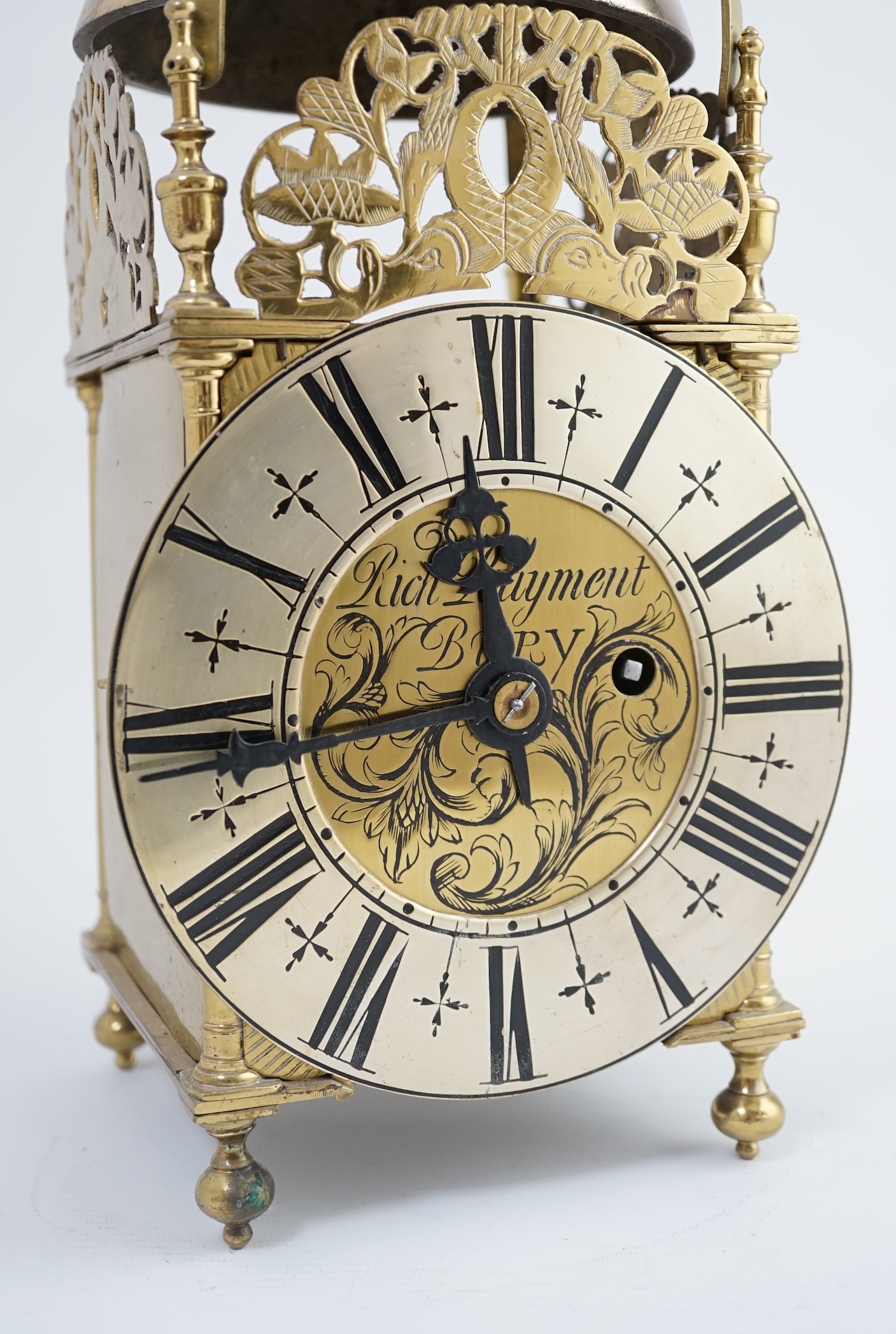 Manner of Richard Rayment of Bury. A Victorian 17th century style lantern clock, in traditional brass case with silvered Roman dial and eight day single fusee movement striking on a bell, 17cm wide, 14.5cm deep, 38cm hig